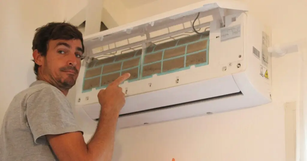 Technicien KaruClim en intervention sur une climatisation